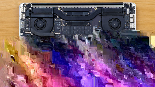 A corrupted photo of a MacBook where the lower half of the image is unrecognizable digital noise.