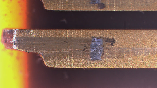 An M.2 connector showing clear damage and signs of material fretting.