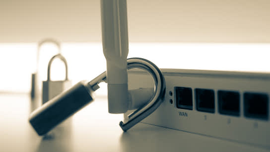 A padlock with an unsecure shackle resting on the antenna of a Wi-Fi router.